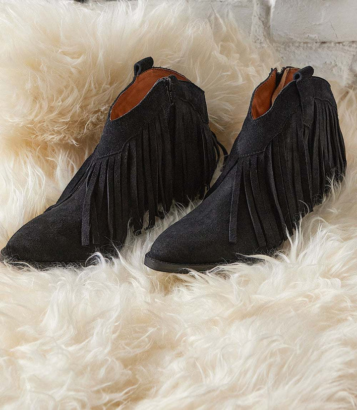 Black suede Seychelles Easy Come Easy Go ankle booties with side fringe, pointed toe, and low block heel.