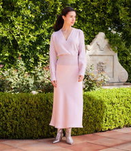 woman wearing petite size sequin wrap sweater with crossover V-neck and drop shoulder sleeves in garden setting