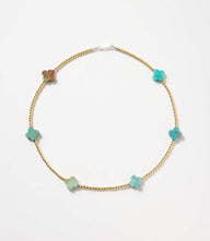 Beaded gold and turquoise accent necklace with flower-shaped stones and gold beads on sterling silver chain