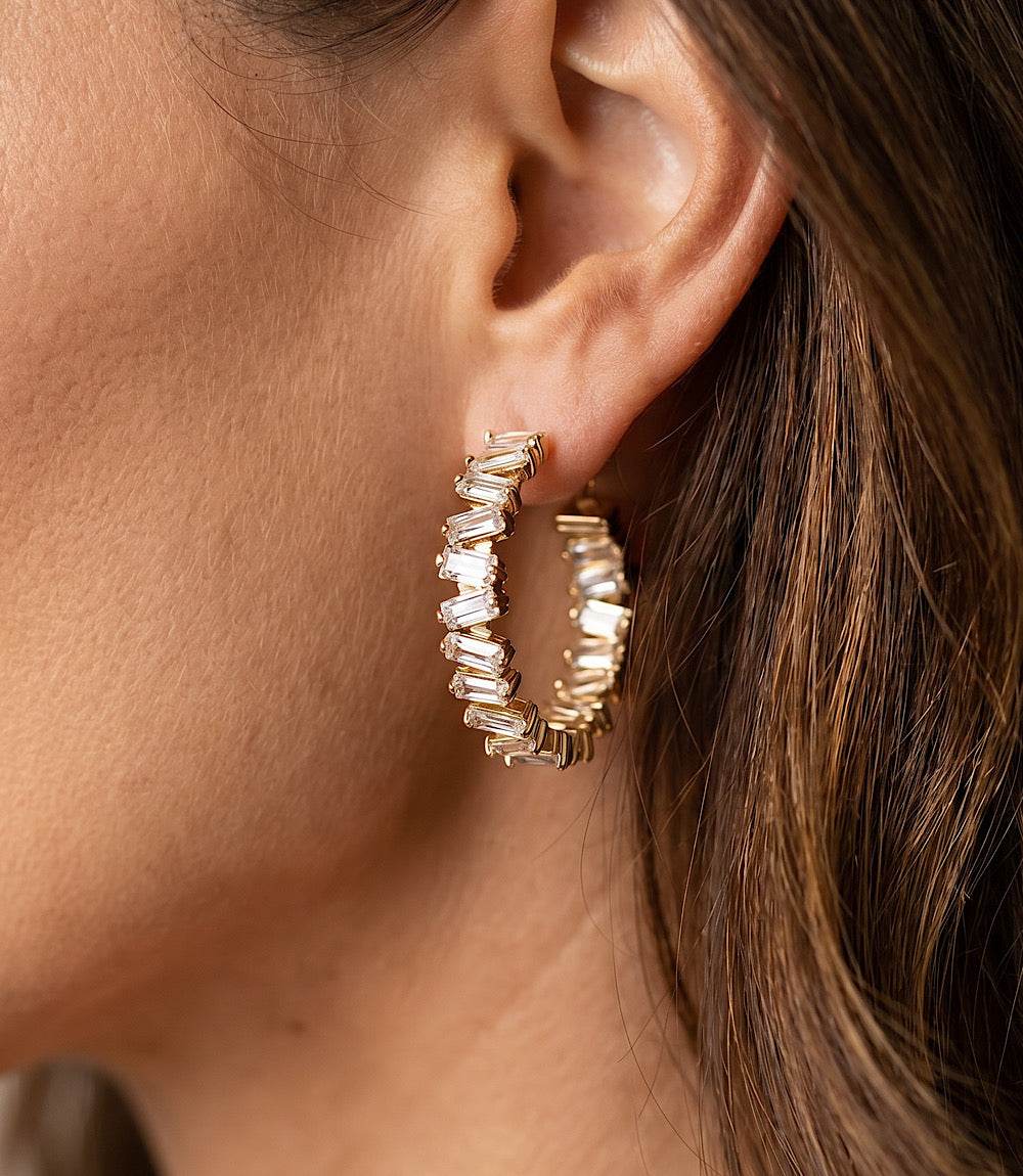 Angled crystal hoop earrings with clear blue crystals and 14k gold finish, 3-inch circumference