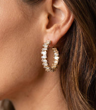 Angled crystal hoop earrings with clear blue crystals and 14k gold finish, 3-inch circumference