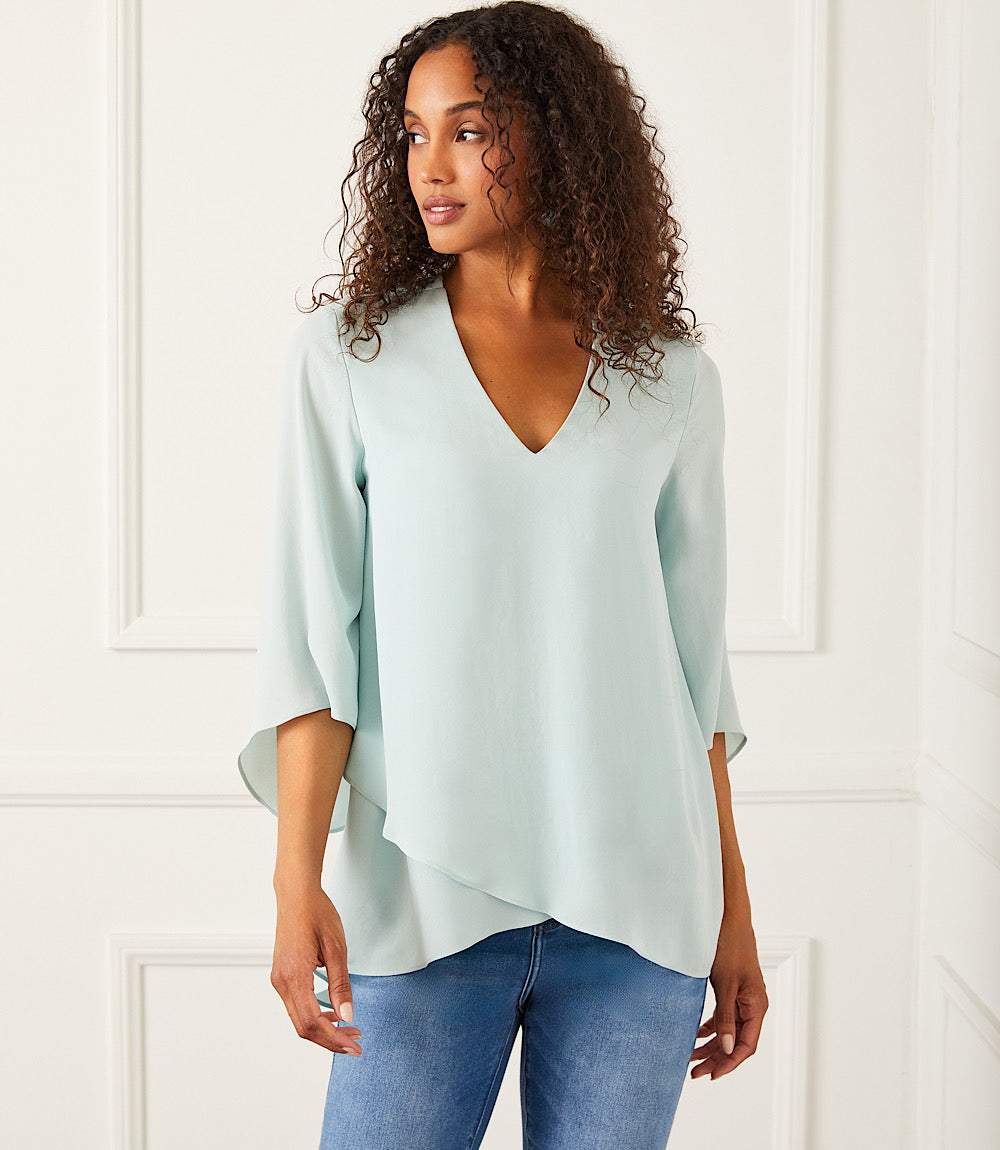 Woman wearing light blue Bracelet Sleeve Asymmetric Top with V-neck and layered hem