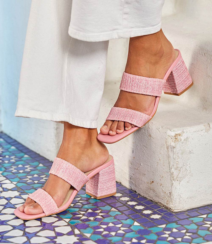 Pink Newport Raffia Strap Heel Sandals with block heel worn with white pants on mosaic tile floor