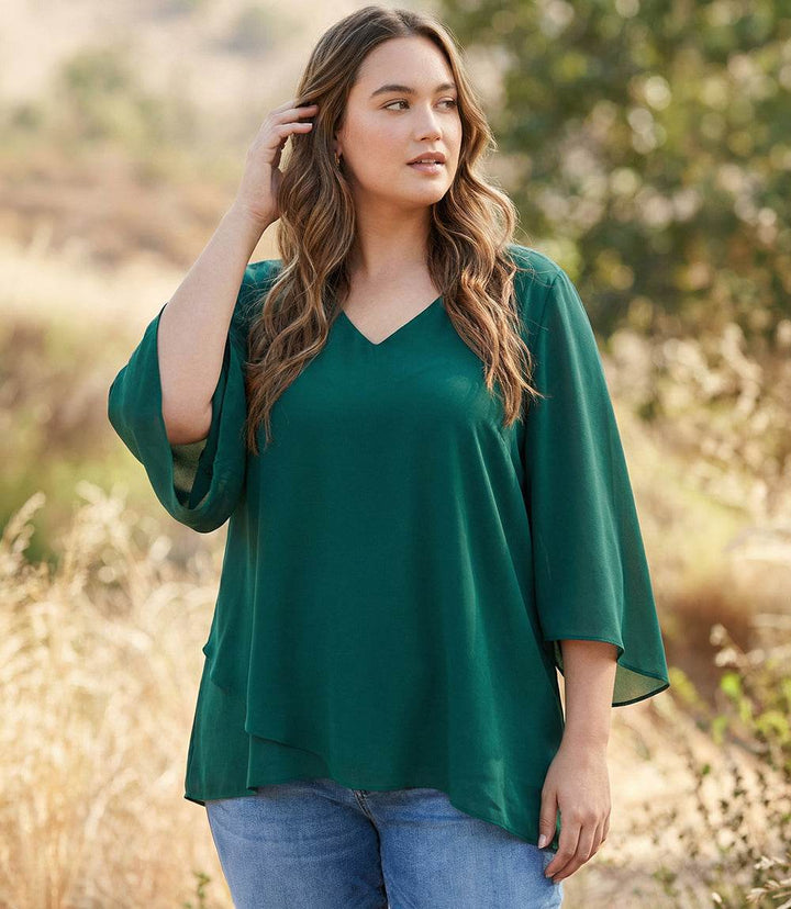 Plus Size Bracelet Sleeve top with silky crepe fabric, V-neck, flare sleeves, and layered asymmetric hem