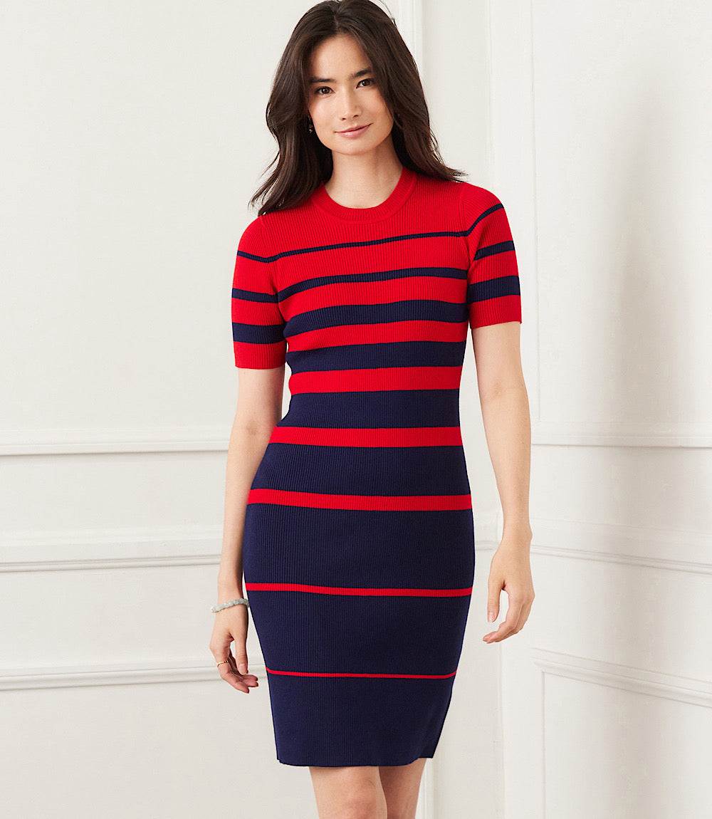 Woman wearing a fitted red and navy stripe ribbed sweater dress with scoop neckline and short sleeves
