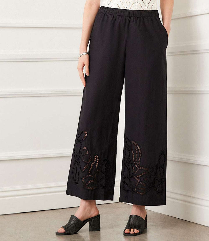Black wide-leg cutout embroidery pants with mid-rise waist and front pockets, made of 100% cotton poplin.