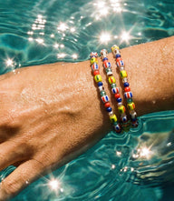 Colorful glass bead wrap bracelet coiled for a layered, lightweight wrist accessory