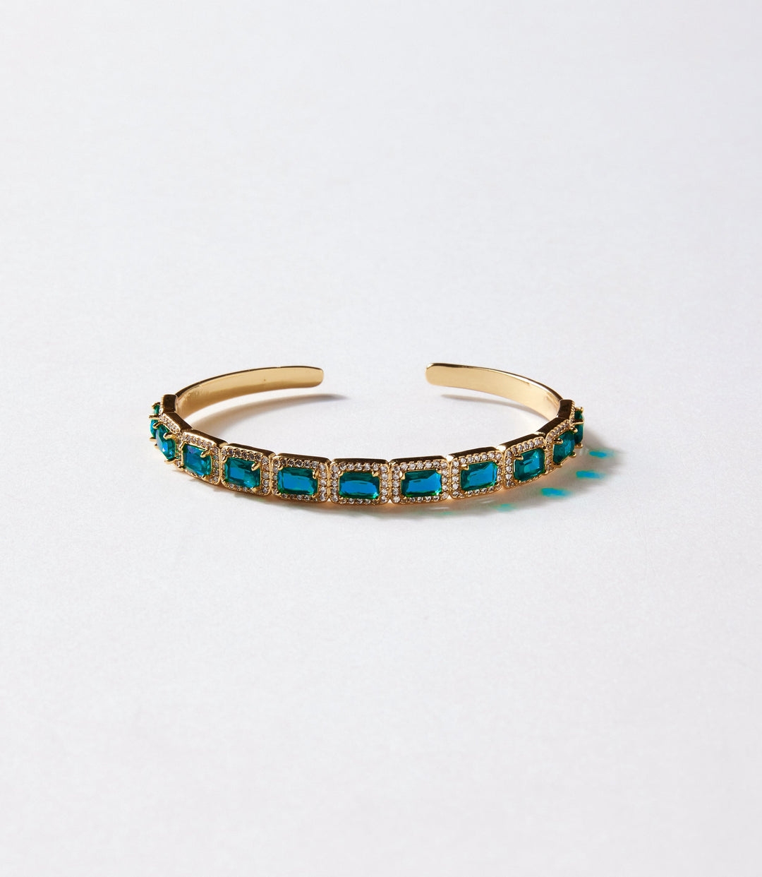 Gold-plated gemstone cuff bracelet with sapphire blue glass crystals, modern open design