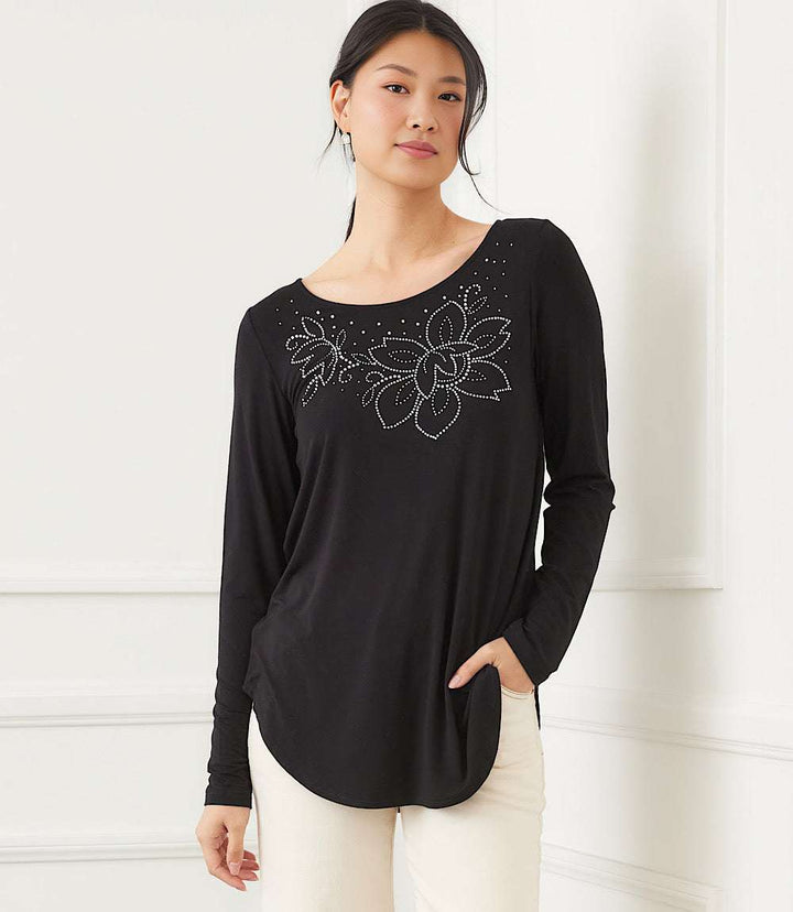 Long sleeve embellished black top with floral detail and curved shirttail hem