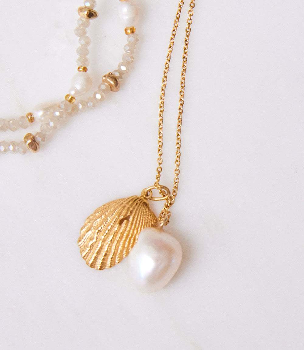 Gold plated shell and freshwater baroque pearl necklace on gold chain