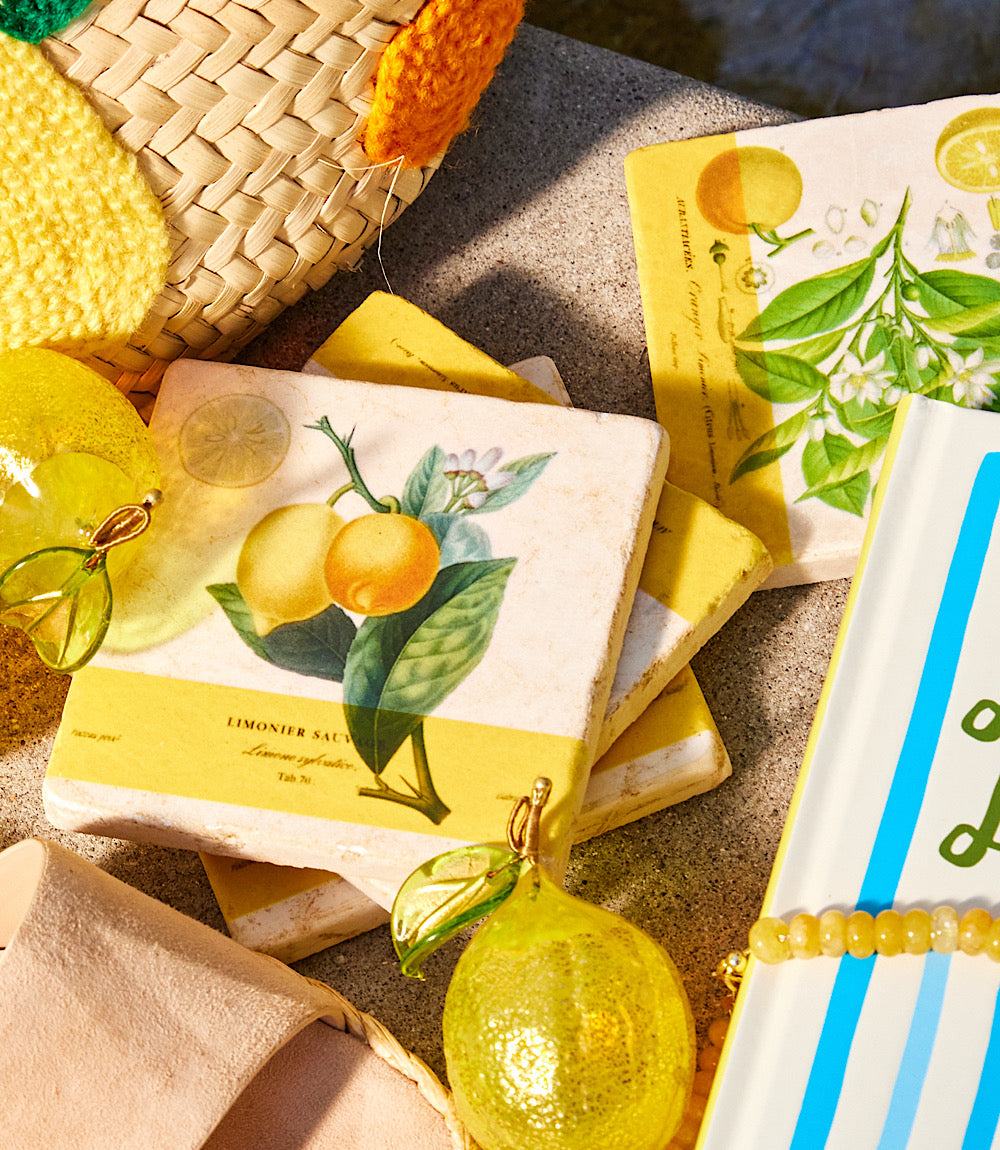 Set of 4 handcrafted lemon marble coasters with cork backing and natural stone texture.