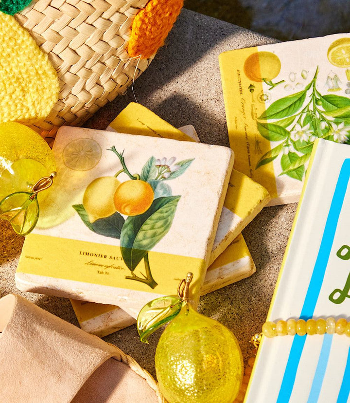 Set of 4 handcrafted lemon marble coasters with cork backing and natural stone texture.