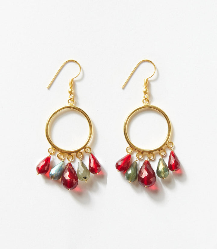 Dangling gemstone hoop earrings with burgundy and smoky gray teardrop stones on gold hoops