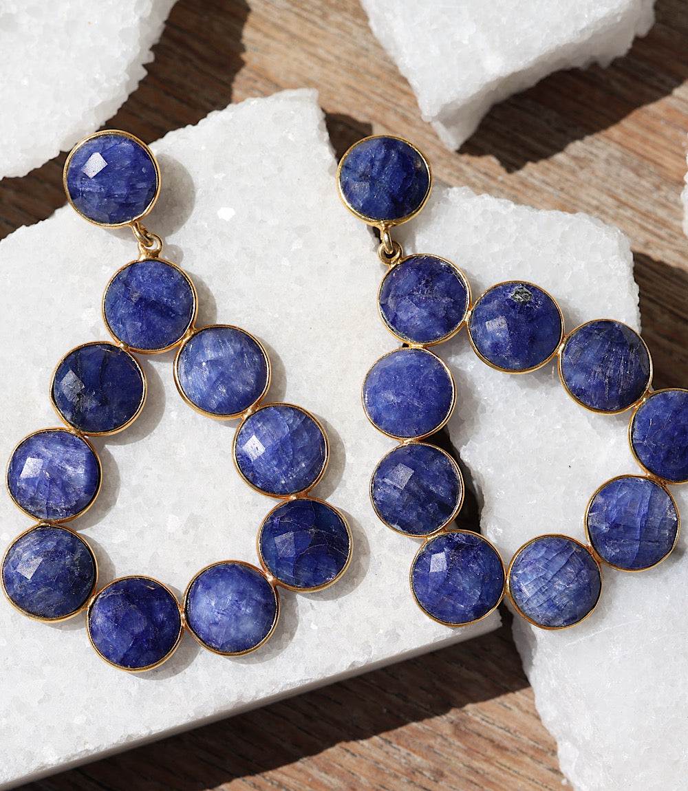 Gemstone bezel drop earrings with sapphire-blue faceted stones in gold-plated bezel setting in teardrop shape
