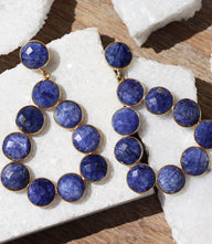 Gemstone bezel drop earrings with sapphire-blue faceted stones in gold-plated sterling silver open teardrop design