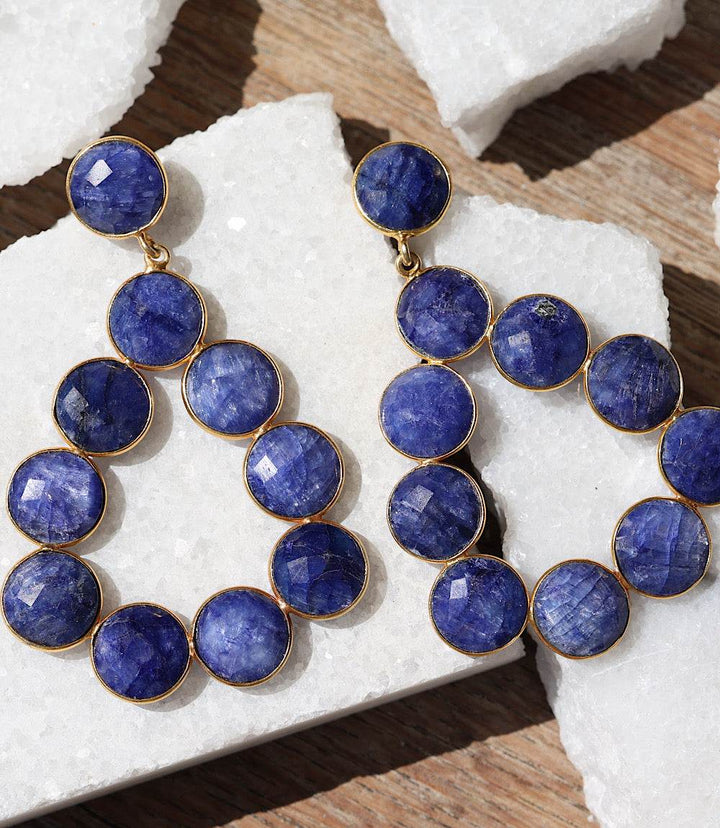 Gemstone bezel drop earrings with sapphire-blue faceted stones in gold-plated bezel setting in teardrop shape