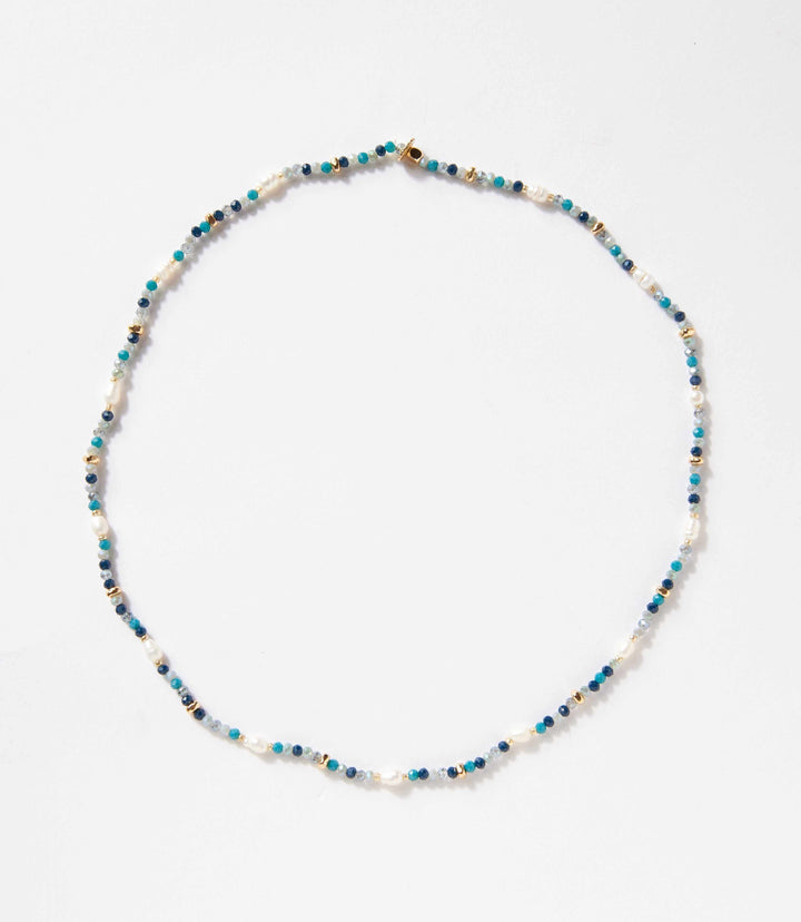 Beaded gemstone and pearl stretch bracelet with mixed blue and white beads on a stretch band