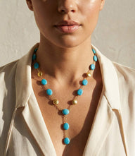 Beaded turquoise and gold lariat necklace with vibrant beads and gold accents in an elegant open-front design.