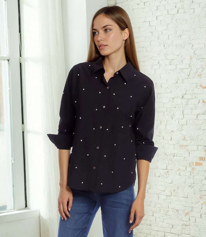 Woman wearing black embellished ruched sleeve shirt with button front and point collar