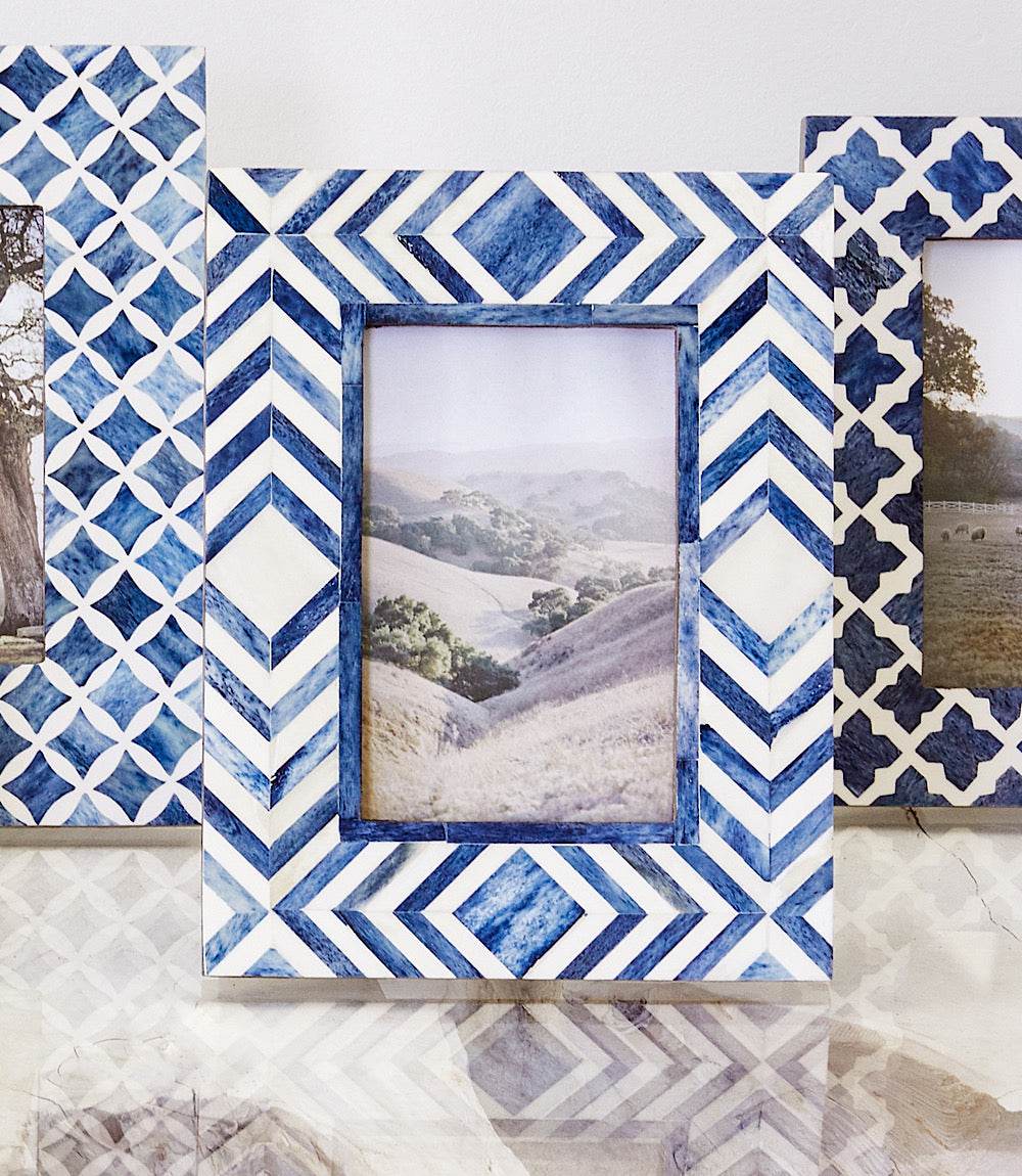 Handcrafted mosaic bone picture frame in blue and white geometric pattern holding 4x6 photo