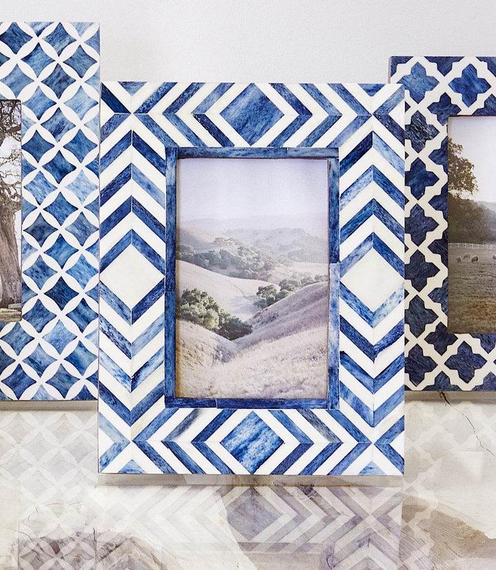 Handcrafted mosaic bone picture frame in blue and white geometric pattern holding 4x6 photo