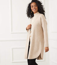 Long sleeve shirttail cardigan with V-neck and button front closure in soft double-brushed knit, mid-thigh length with rounded hem and side slits.