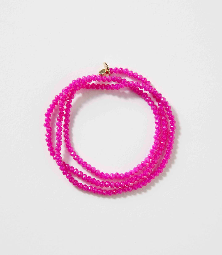 Pink crystal beaded stretch bracelet with multiple strands and gold clasp
