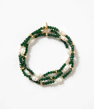Beaded gemstone and pearl stretch bracelet with green beads and white pearls wrapped in a spiral