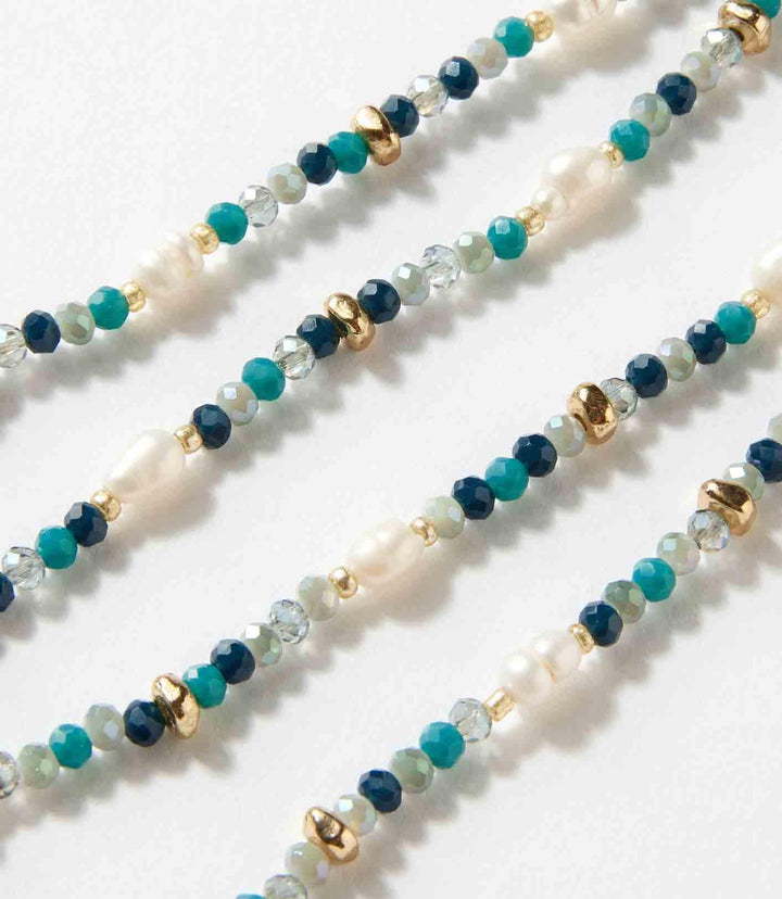 Beaded gemstone and pearl stretch bracelet with mixed blue and green beads and gold accents
