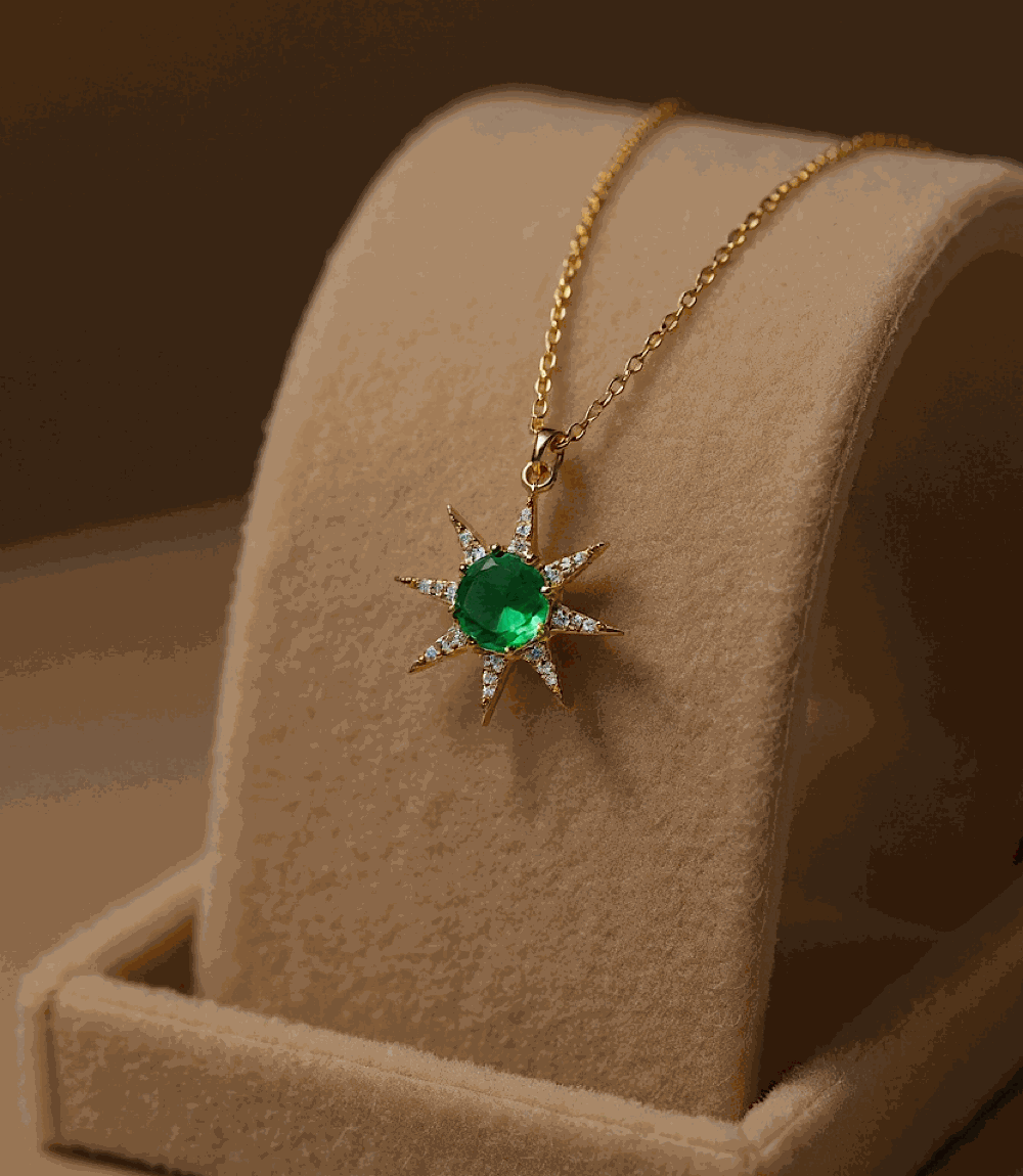 Gold sunburst necklace with green tourmaline cabochon pendant on gold chain