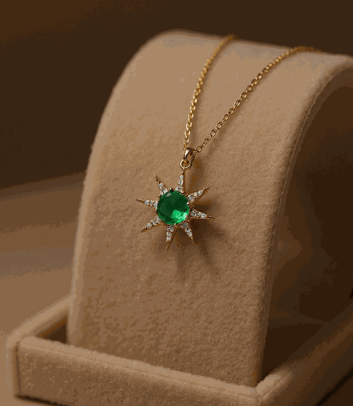 Gold sunburst necklace with green tourmaline cabochon pendant on gold chain