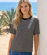 Woman wearing a comfortable stripe short sleeve top with crew neck and relaxed fit