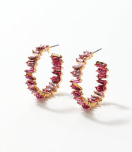 Angled crystal hoop earrings with pink crystals and 14k gold, 3-inch hoops catching the light elegantly
