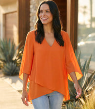 Silky crepe Bracelet Sleeve Asymmetric Top with V-neck, flare sleeves, and layered asymmetrical hem.