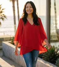 Bracelet Sleeve Asymmetric Top in silky crepe with flare sleeves and layered asymmetrical hem