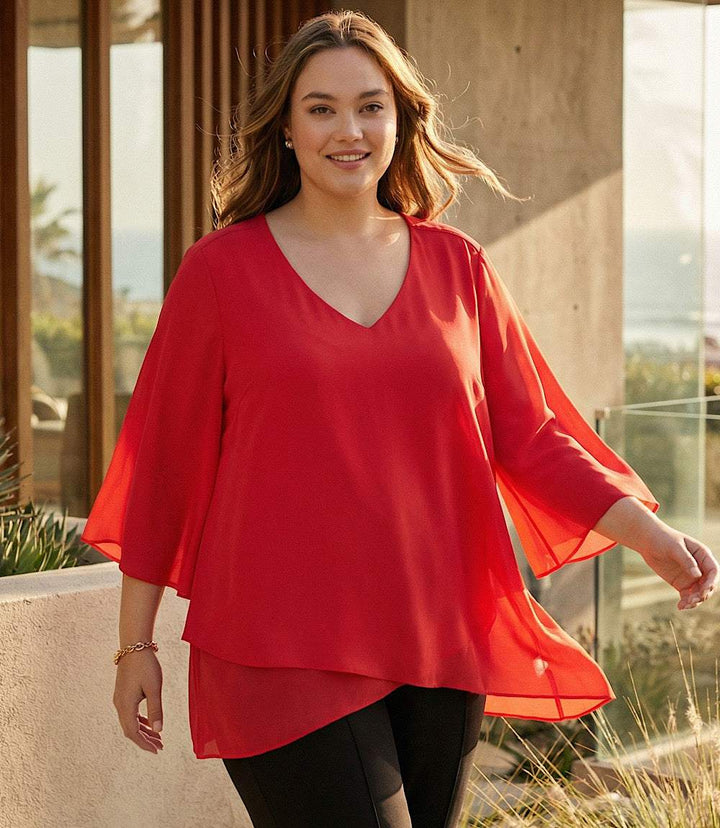Plus size bracelet sleeve asymmetric top in silky crepe with layered hem and flare sleeves