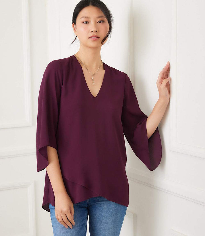 Petite size bracelet sleeve asymmetric top in deep plum with V-neck and layered hem made from silky crepe fabric