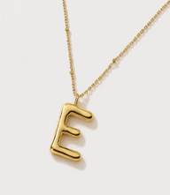 Gold bubble letter charm necklace with 16K gold plated stainless steel and 15-inch chain.