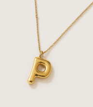 Gold bubble letter charm necklace on gold-plated stainless steel chain