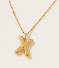 Gold bubble letter charm necklace with 16K gold over stainless steel and polished finish