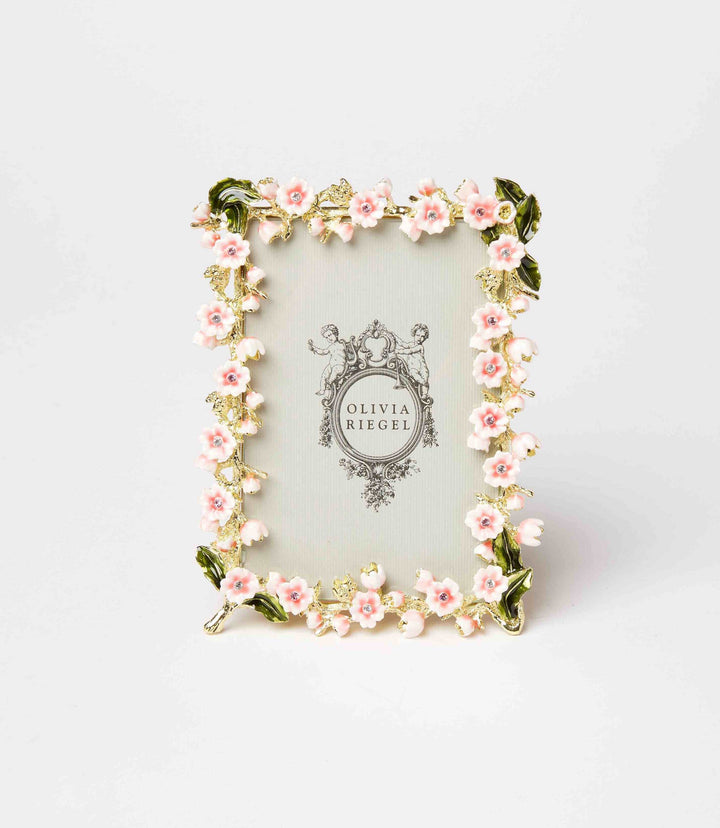 Floral enamel and crystal photo frame with pink flowers and gold pewter finish, elegant and tarnish-resistant design.