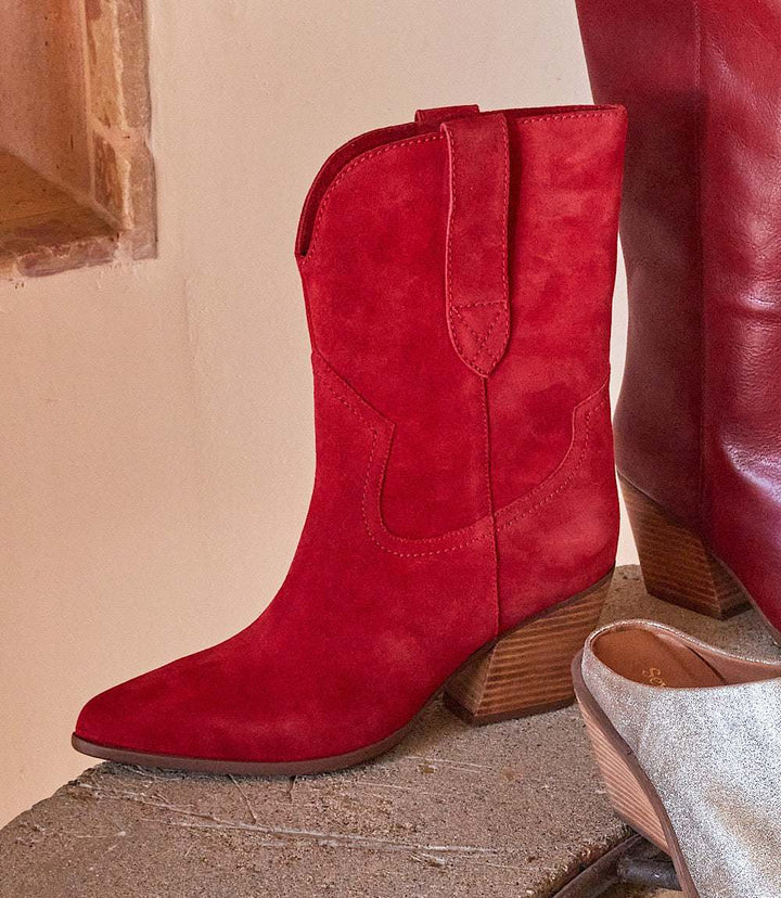 Red Seychelles Line Dance Western boots with pointed toe and stacked heel on a rustic surface.