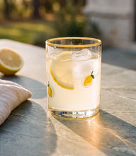 Hand-painted lemon glass tumbler with vibrant lemon motifs, 16 oz capacity, 4.5" tall, perfect for cocktails and lemonade