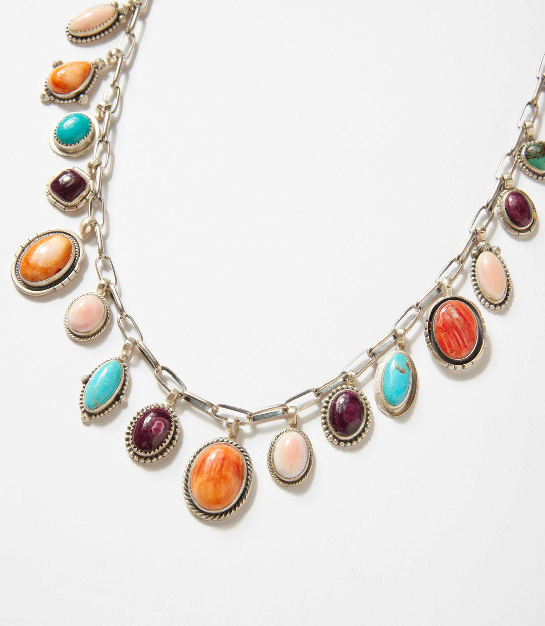 Turquoise, spiny oyster, and pink conch stone necklace with sterling silver bezels on link chain