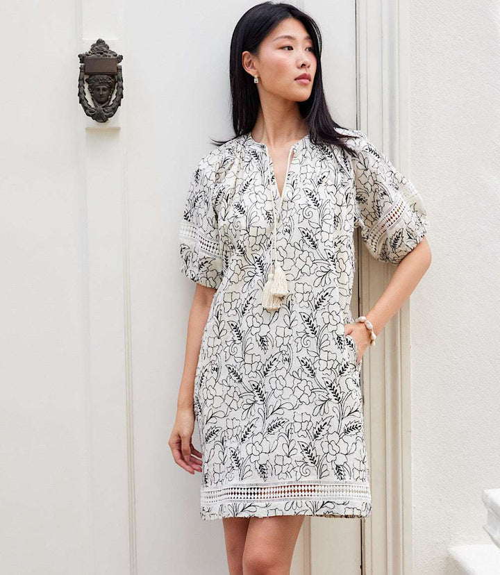 Cream Puff Sleeve Tassel Dress with black floral print, elastic cuffs, tie-neck, and side pockets