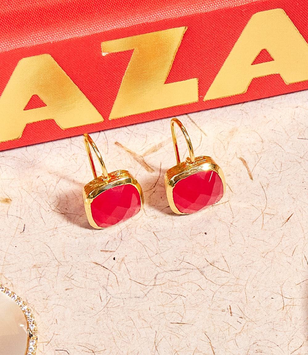 Quartz drop earrings featuring cushion cut red ruby stones set in 22k gold plated brass.