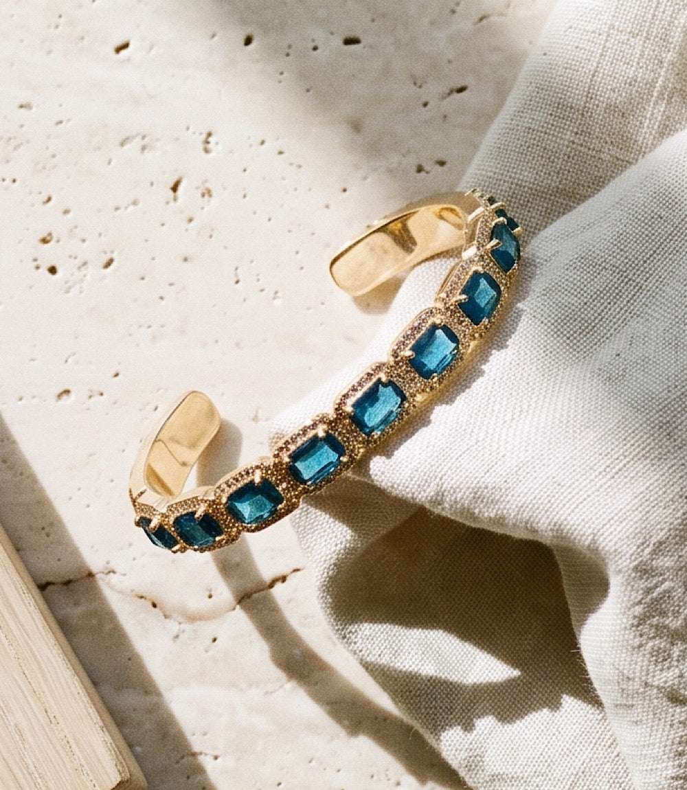 Gemstone cuff bracelet with sapphire blue glass crystals set in 14K gold-plated brass open cuff design