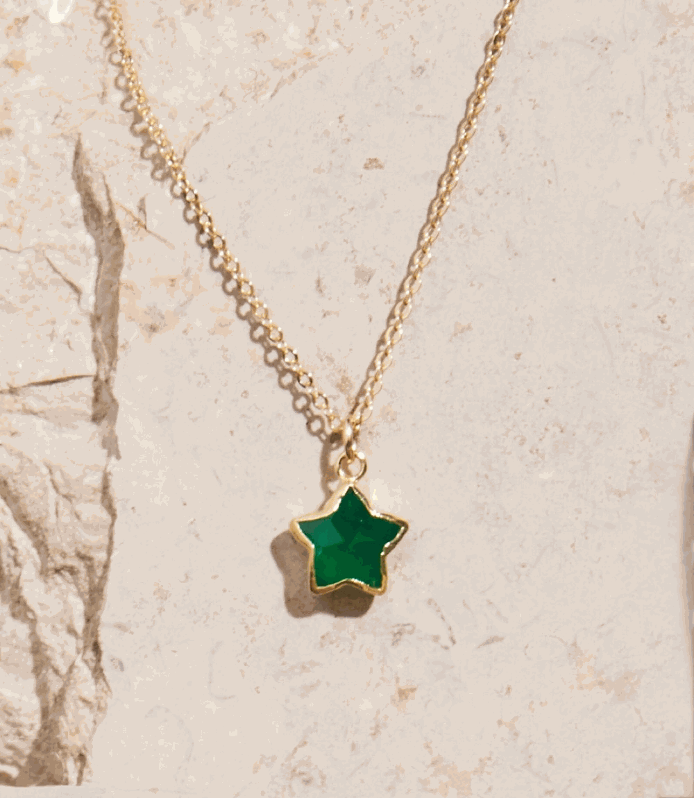 Green Onyx star-shaped pendant necklace with 14K gold filled chain on stone background