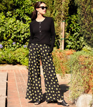 Petite size wide-leg pants with black and yellow floral print, elastic waistband, and side pockets