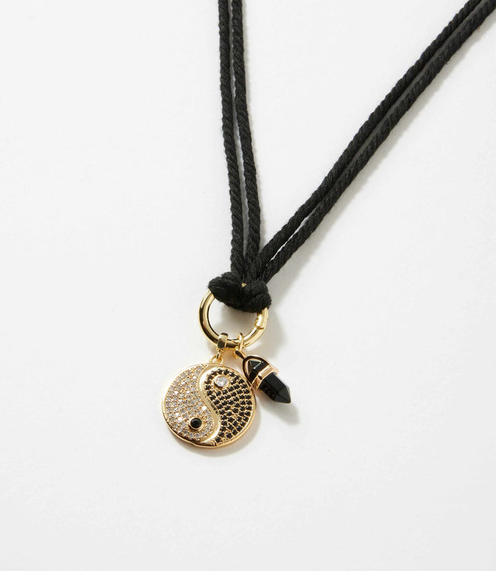 Gold plated yin yang disc and black gemstone point pendant on adjustable black cotton cord necklace